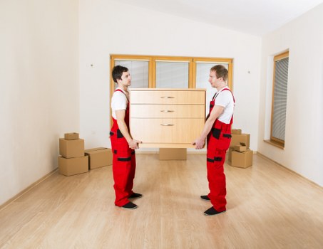 Packed moving boxes and furniture prepared for transport and storage
